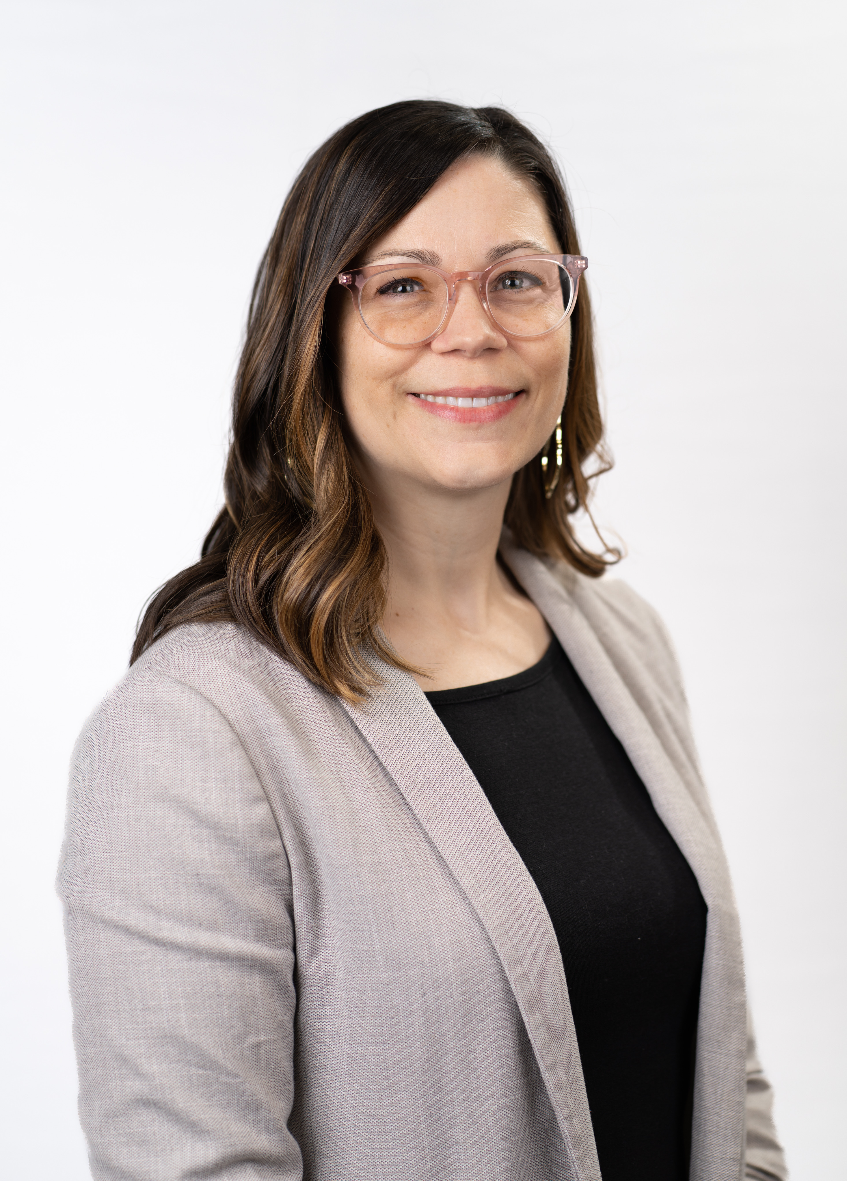 Social worker Heather Van Diest, MPH, MSSW, LCSW, wearing a cardigan and smiling in front of a white background.