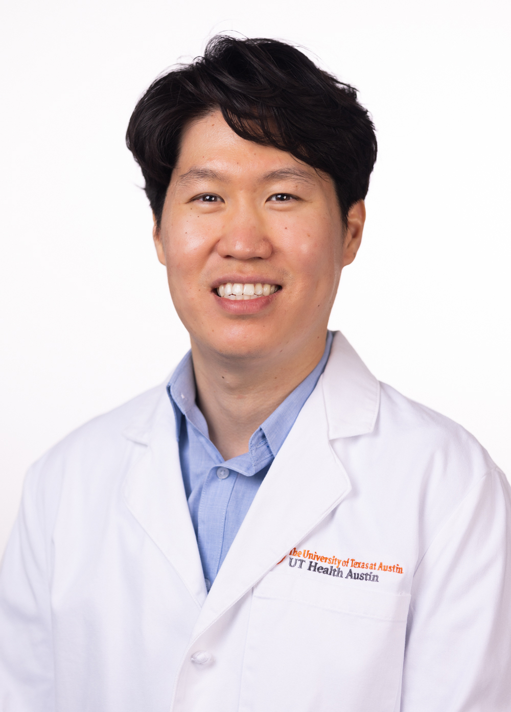 Dr. Hwarang Stephen Han wearing a white coat and smiling in front of a white backdrop.