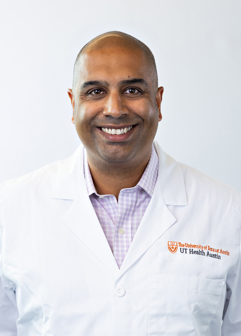 Colon and rectal surgeon S. Joga Ivatury, MD, MHA, wearing a white coat and smiling in front of a white backdrop.