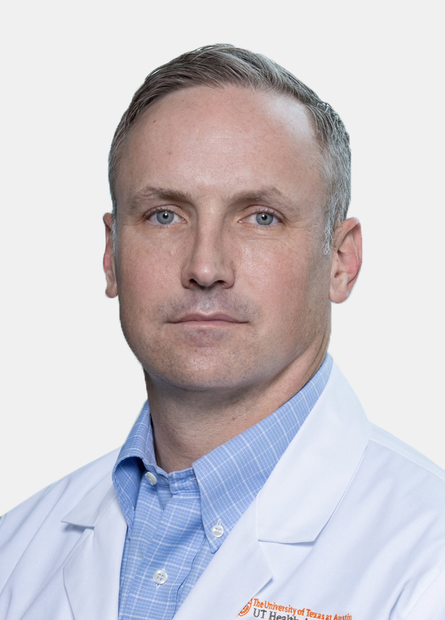 Dr. Joseph DuBose wearing a white coat and posing in front of a white backdrop