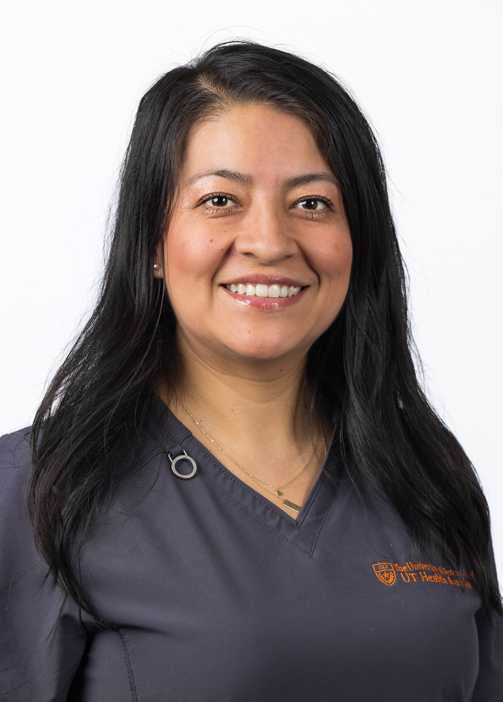 Mayte Silva-Juarez, BSN, RN, wearing dark scrubs and smiling in front of a white background.