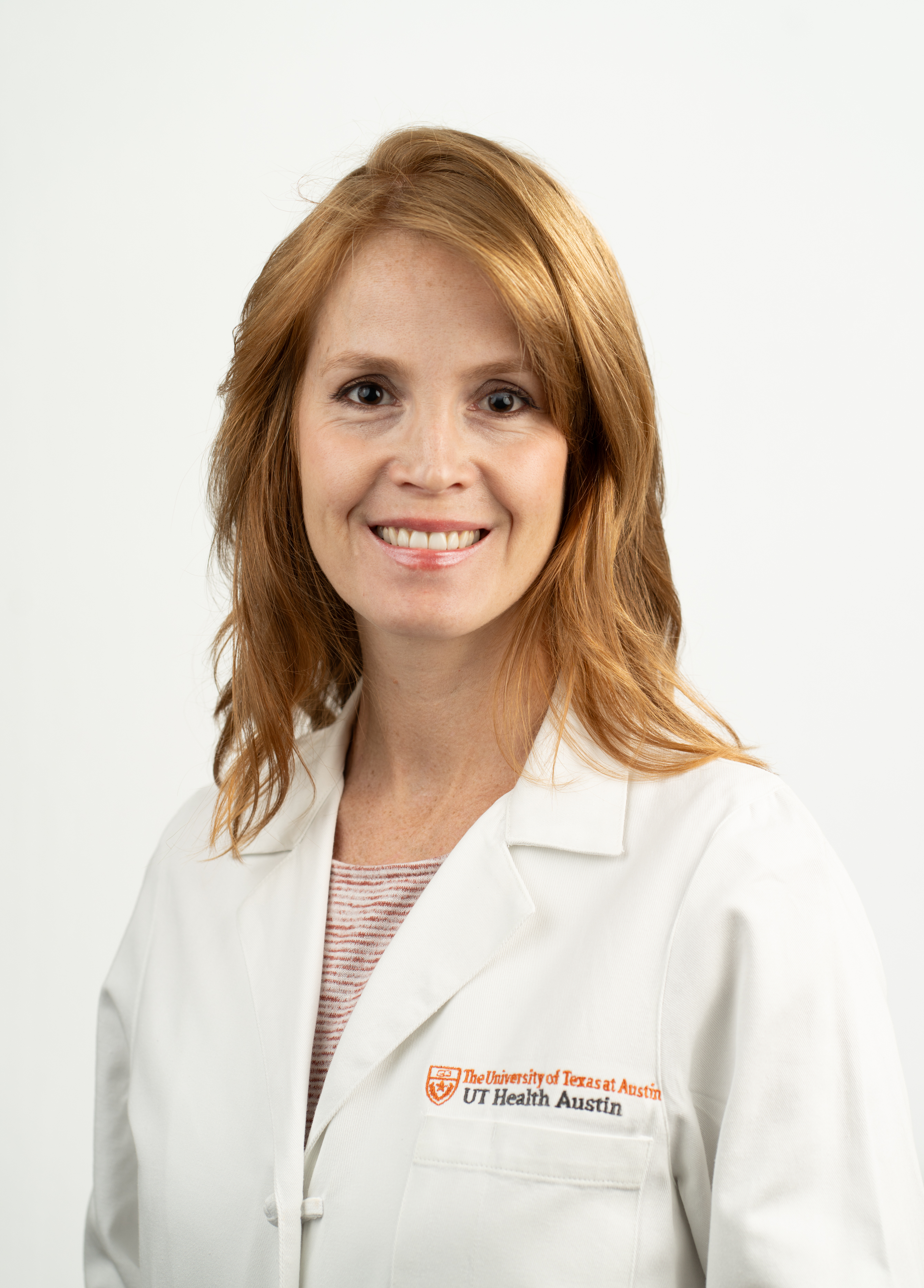 Nurse practitioner Meghan Purdy, FNP-C, wearing a white coat and smiling in front of a white background.