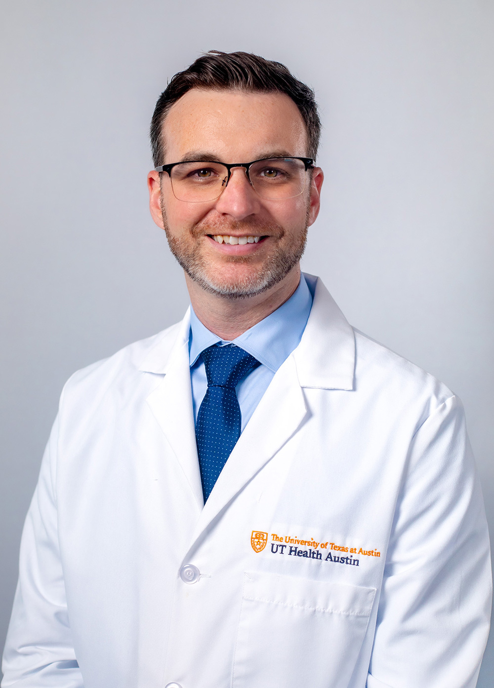 Internal medicine specialist W. Michael Brode, MD, wearing a white coat and smiling in front of a white backdrop.